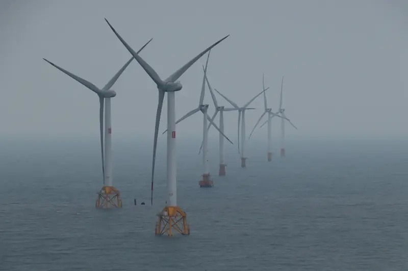 Offshore wind turbines generating clean energy in the ocean breeze.